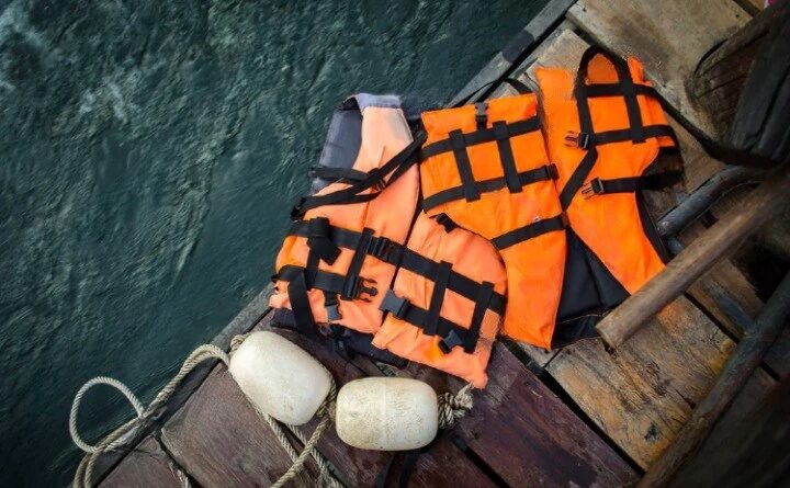 life vest on wooden background 1600x